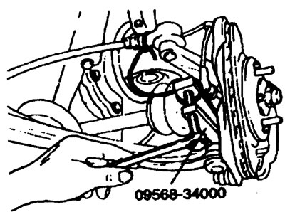 4. Снимите тормозной механизм в сборе и подвесьте его с помощью проволоки.
